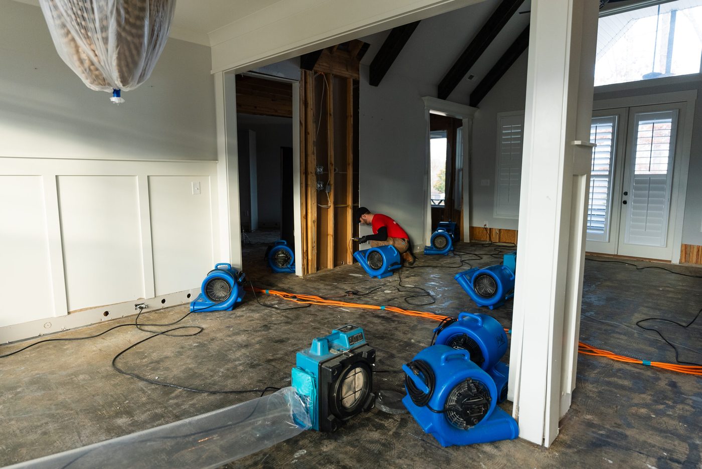 Air movers and equipment running during a water damage restoration job